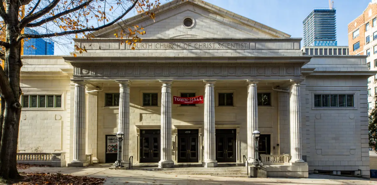 Exterior of the Fourth Church of Christ, Scientist, venue for JLF Lit Seattle event, with a red 'Town Hall Seattle' banner above the entrance.